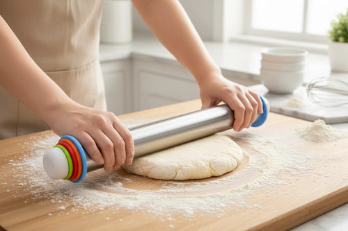 Adjustable rolling pin with thickness rings rolling dough on kitchen surface